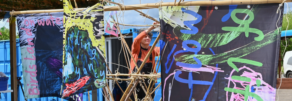 Artist Sarah Kenchington hangs sails by Peter and Rossi.