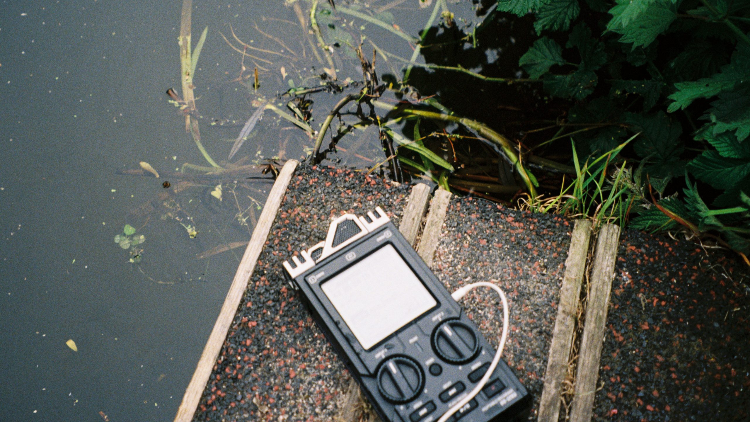 Zoom recorder lies next to canal