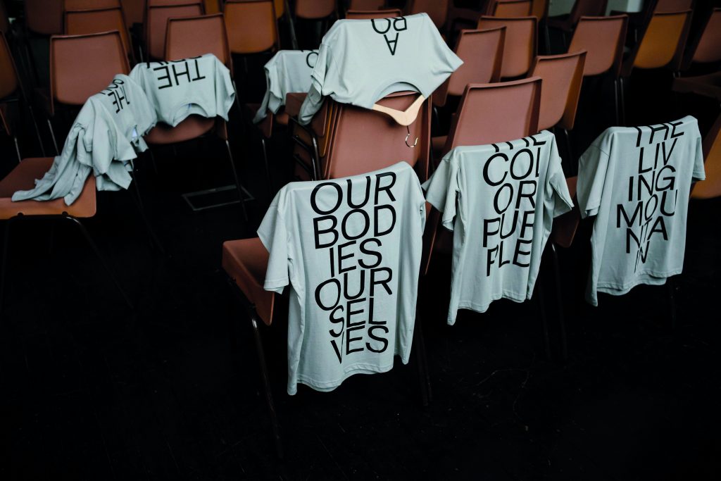 T-shirts are draped over chairs.
