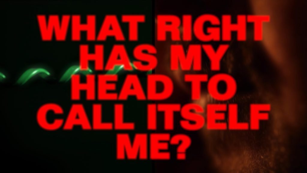 Red bold text from Edward Gwyn Jones' film Twisted Pair reading "What right has my head to call itself me?" over an ambient background