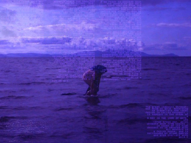 Still from film by Kialy Tihngang, For Those in Peril on the Sea, showing a person behind over in a purple sea under a dreamlike sky. Text is faintly overlaid but not readable.